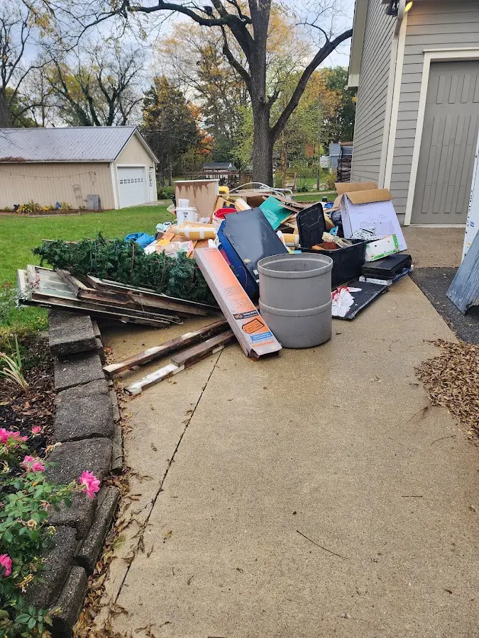 Dumpster being loaded with debris for Residential Dumpster Rental in Calhoun